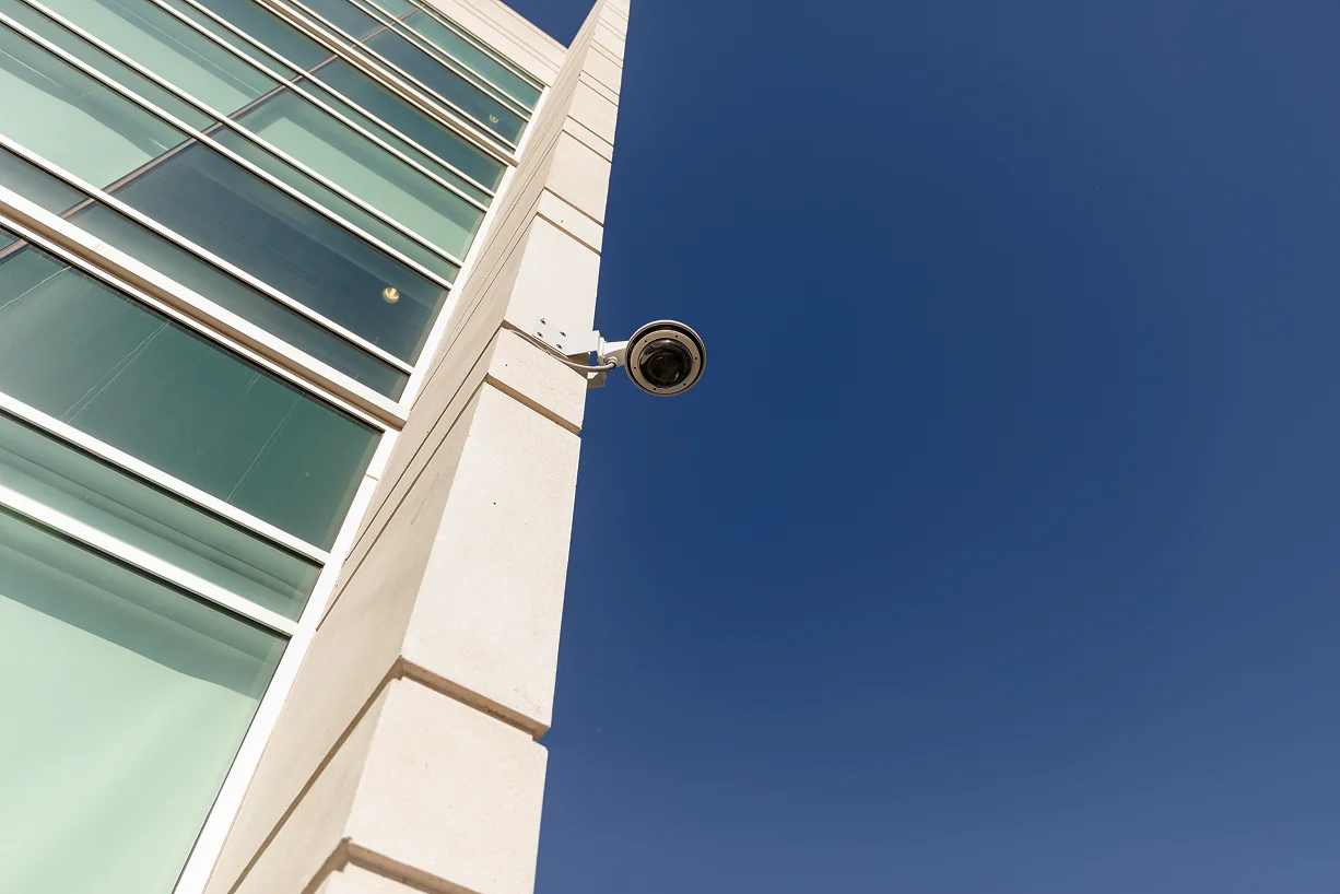 close in shot of exterior camera on campus building