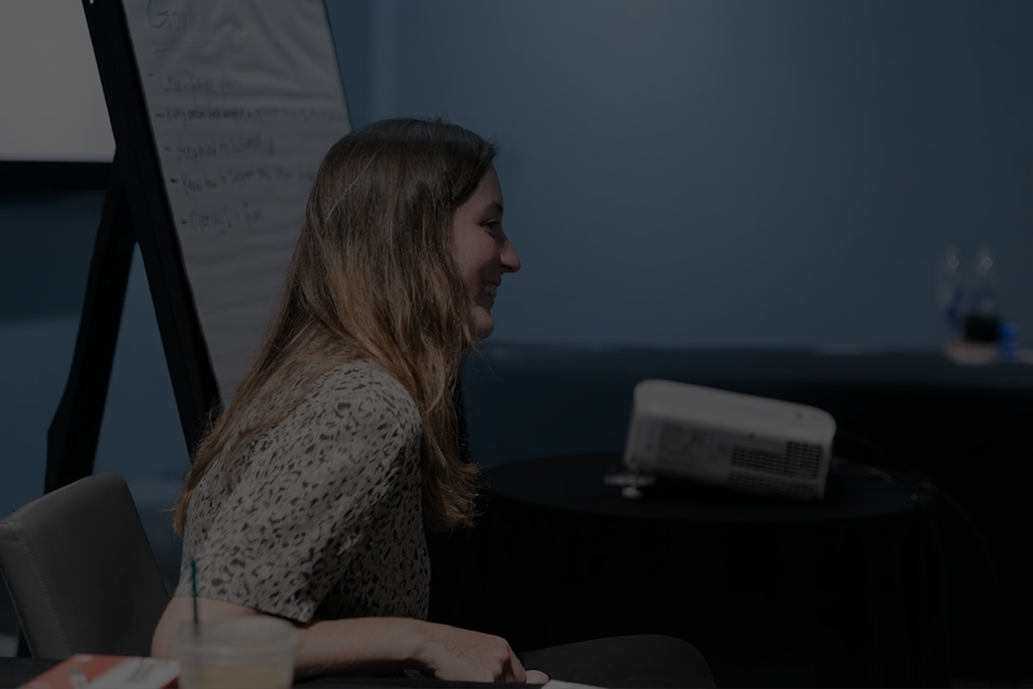 Cobalt team member smiling in front of a poster
