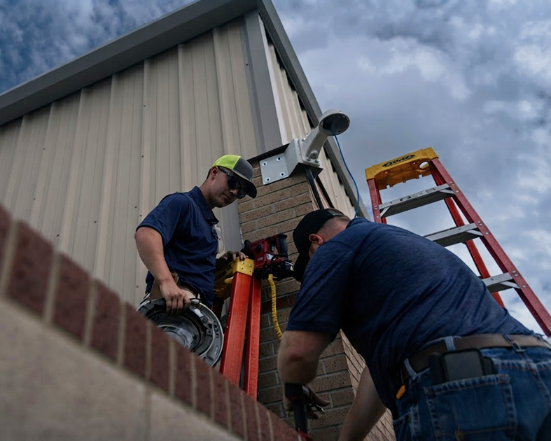 Cobalt technicians performing maintenance on a surveillance camera