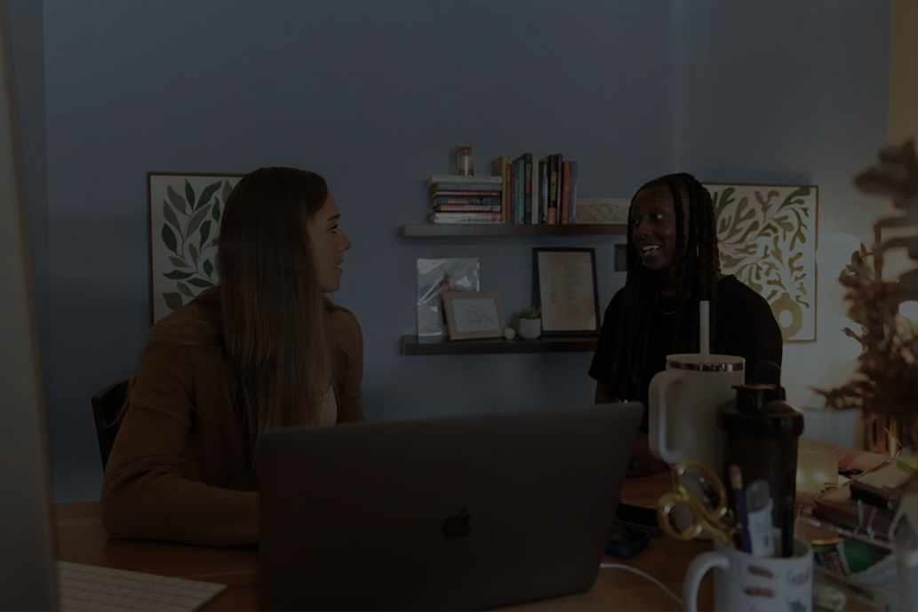two Cobalt team members chatting in an office