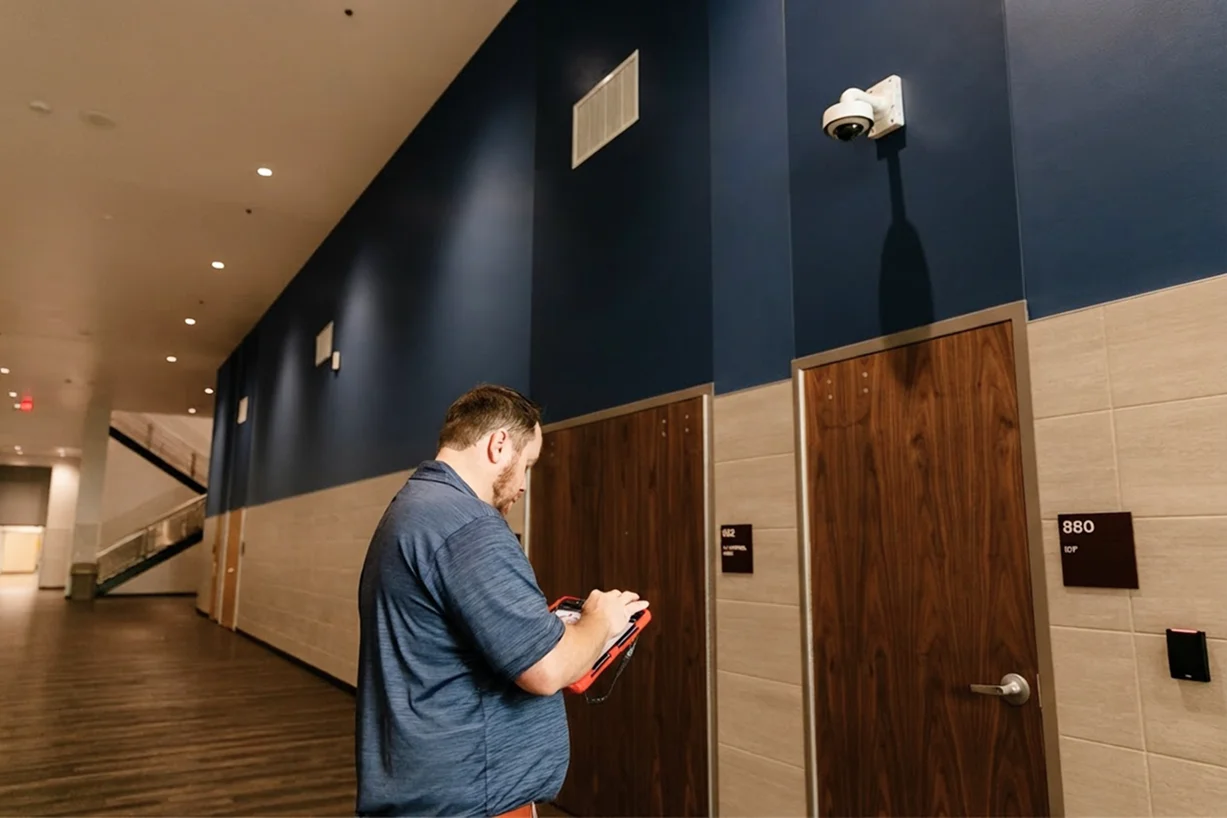 technician performing tests on interior surveillance camera